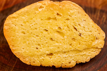 a piece of aged cheese on a wooden platter