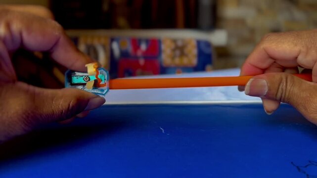  Orange pencil sharpening video with blue sharpener. Pencil and sharpener video.