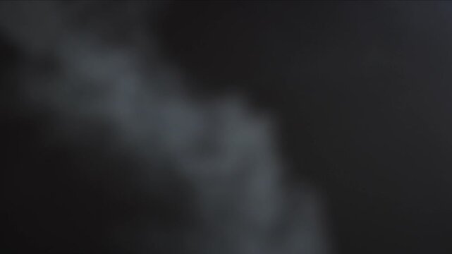Black background and smoke. Lots of cigarette smoke. Suitable for effects in various videos. It's a pity for the environment. Stop smoking in public places. Thick white smoke on a black background.