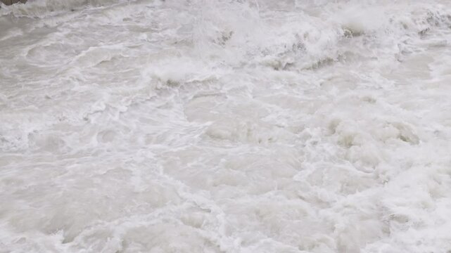 muddy seething water in slow motion, closeup full-frame background