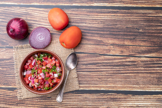 Vinagrete, typical brazilian sauce with tomato, onion, vinegar, olive oil and parsley and copy space