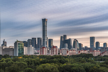 Obraz premium The unique landscape of modern buildings against the backdrop of green trees in the skyline of Beijing, China