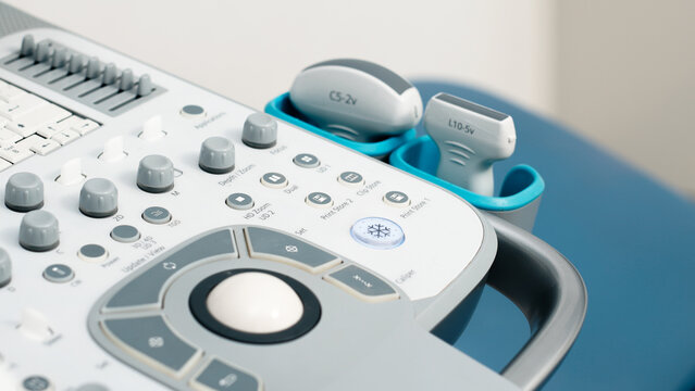 Ultrasound diagnosis of a patient in the clinic, the doctor operates the ultrasound transducer. The concept of modern medical technology ensuring precision and reliability in diagnostics.