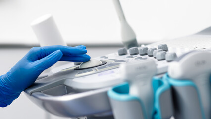 Close-up of ultrasound equipment with a probe in a modern diagnostic center. The concept of...