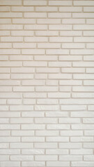 Fototapeta premium A white brick wall with evenly spaced, textured bricks Vertical Mobile Wallpaper