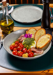 Salad with cherry tomatoes, bread, white cheese and ham