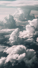 Aerial view of towering clouds illuminated by sunlight Vertical Mobile Wallpaper