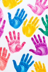 Different colorful hands prints on white background. Diversity and equality concept.