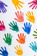 Fototapeta premium Different colorful hands prints on white background. Diversity and equality concept.