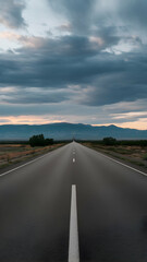 Naklejka premium A straight road stretching into the horizon under a dramatic stormy sky Vertical Mobile Wallpaper
