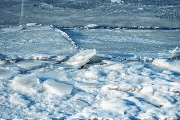 Ice ridges and snow illuminated by the sun as a background.