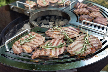 A beef steak from marbled beef seasoned with sprigs of rosemary 