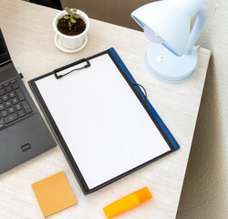 Shot of the plastic folder on the office desk with paper clip holder on the top and other office...