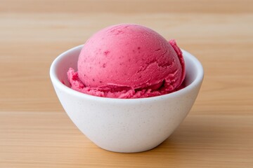 A frozen blackcurrant sorbet scoop melting slightly under warm lighting