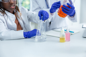 Two people working with the vacutainers in a school laboratory