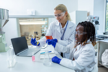 Two people working with the vacutainers in a school laboratory