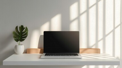 Fototapeta premium Sleek Minimalist Workspace with White Desk and Laptop in Natural Light