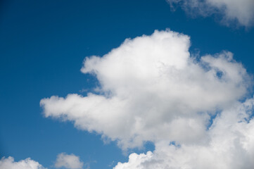 Beautiful blue sky with white fluffy big clouds