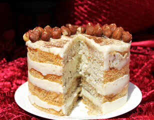 Tiramisu mousse cake on a red silk tablecloth