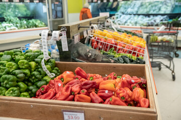 sweet red and hot green peppers sold at the farm store. Bell peppers in crates.
