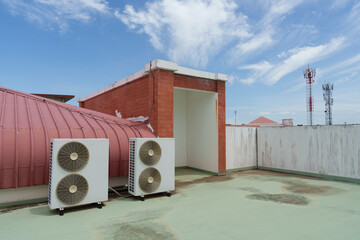 Air compressor or air condenser unit located on support outside building to heat released...