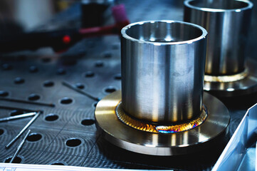 Freshly welded seam on a stainless flange. Production of metal products from stainless steel by...