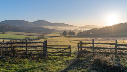 Sunrise over misty valley farmland