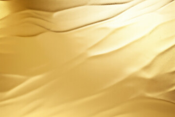 Abstract gold background. Satin or silk fabric texture. 