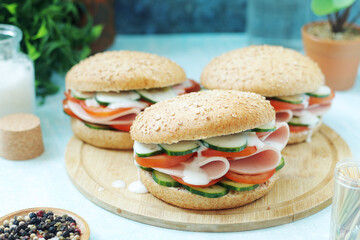 Bun sandwiches with salami and vegetables	