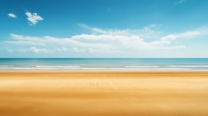 Fototapeta premium A vast seascape where golden sand meets the endless blue sky on the horizon, creating a serene beach landscape.