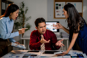 Fototapeta premium Three people are arguing in a room with a lot of papers on the table
