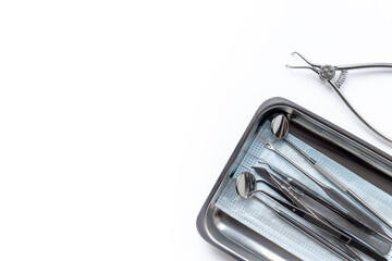 Dental steel instruments for dental prosthetics and oral treatment on a white background. Dentist...