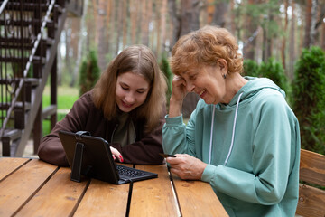 A teenage girl and an older woman spend time together.