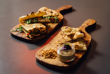 Veal and Roasted Pepper Pizza-Sandwich and Crispy herb focaccia - composition with Sandwiches Served on Wooden Platters in a Rustic Setting