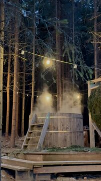 Relaxing evening in wooded hot tub with glowing lights
