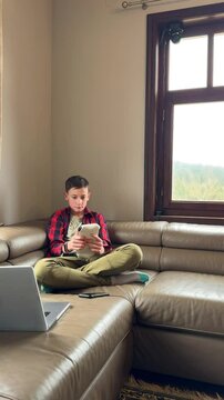 Young man engaged in reading on a cozy sofa