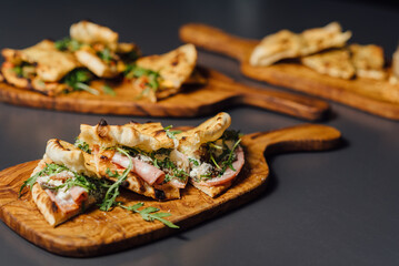 Pizza-Sandwich with Mortadella and Roasted Eggplant – composition with Pizza Sandwiches Served on Wooden Platters in a Rustic Setting