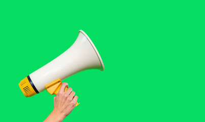 Person holds megaphone against green background, emphasizing communication and outreach efforts...