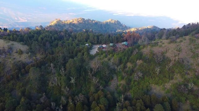 Drone view of cabins on forested mountain at the nevado de colima national park