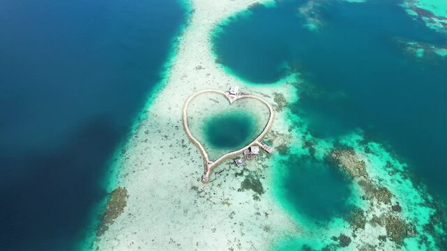 Fish cages in Maluku are heart-shaped floating fish farming areas, surrounded by clear sea water.
