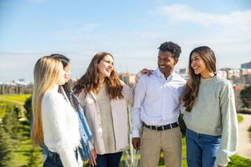Happy multi ethnic friends enjoying time together in a park