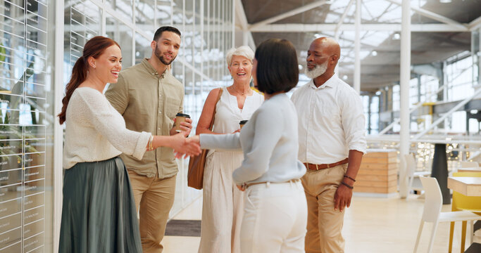Handshake, meeting and business people in office building lobby at corporate, convention, global company for networking. Diversity employees shaking hands for hello, welcome and b2b team introduction