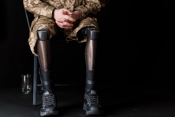 Veteran Seated with Advanced Bionic Leg Prosthesis in Military Camouflage