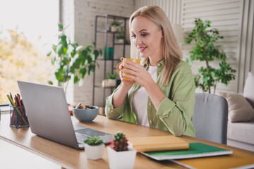 Young woman relaxing and enjoying her leisure time with coffee in a stylish living room during the day