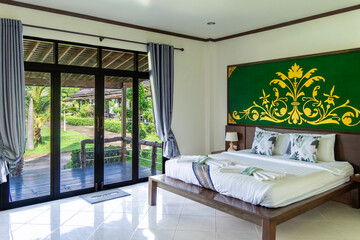 Elegant bedroom in a tropical resort with vibrant decor and modern furnishings