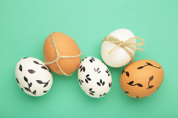 Easter background - white easter egg with flowers inside on mint background. Happy easter, spring, summer floral concept