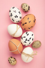 Composition with Easter eggs on pink background. Top view