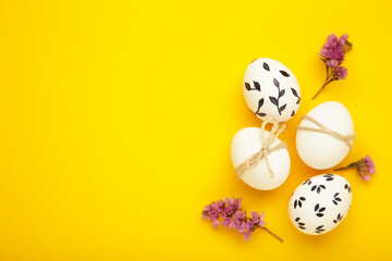 Easter background - white easter egg with flowers inside on yellow background. Happy easter, spring, summer floral concept