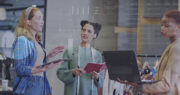 Image of financial data processing over diverse female fashion designers in office - Powered by Adobe