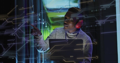 Image of data processing and african american male it technician with laptop by computer servers